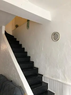 a staircase in a house with black stairs at La casa Trivala in Carcassonne