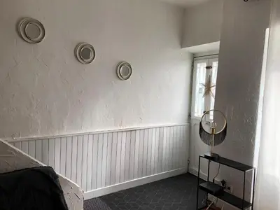 a room with two plates on the wall and a window at La casa Trivala in Carcassonne