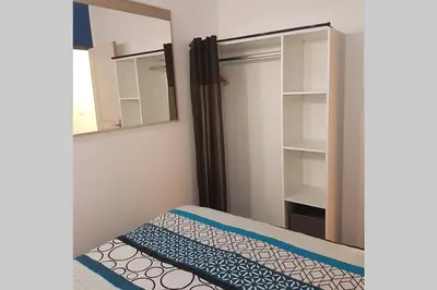 a small bedroom with a bed and a mirror at restez zen in Carcassonne