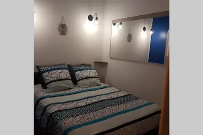 a bedroom with a bed and a mirror at restez zen in Carcassonne
