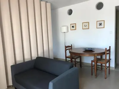 a living room with a couch and a table at l-Ostalet in Bages