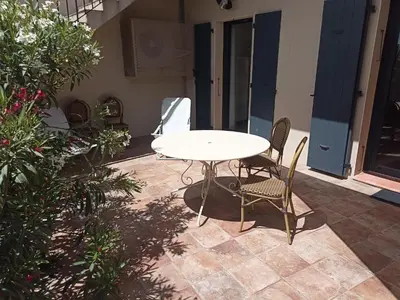 a white table and chairs on a patio at l-Ostalet in Bages