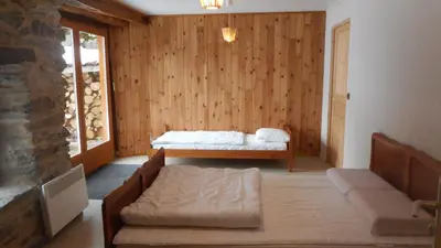 a living room with a bed and a couch in it at Gîtes Le Paradoxe des Pyrénées in Montferrier
