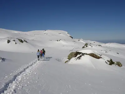 a group of people walking up a snow covered mountain at Gîtes Le Paradoxe des Pyrénées in Montferrier