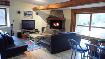 a living room with a couch and a fireplace at Gîtes Le Paradoxe des Pyrénées in Montferrier