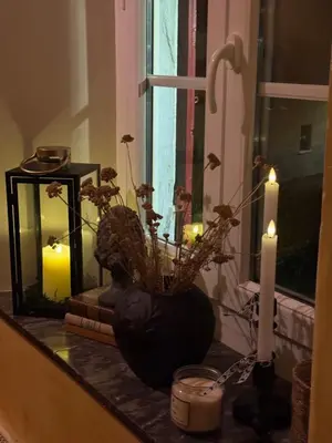 a dining room with two tables with candles on them at Le Patio Des Senteurs in Verzeille
