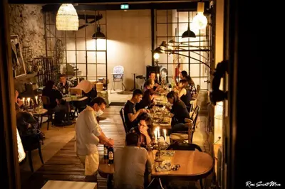 a group of people sitting at tables in a restaurant at Logis Hotel Nature Cathare in Léran