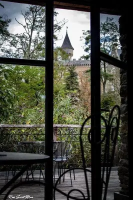 a view of a balcony with chairs and a building at Logis Hotel Nature Cathare in Léran