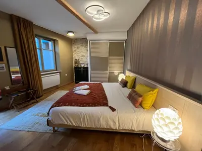 a bedroom with a large bed with yellow pillows at Logis Hotel Nature Cathare in Léran