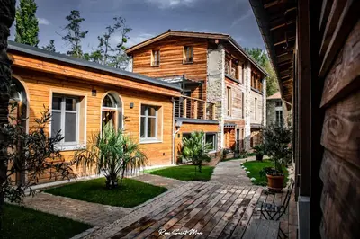 a view of a wooden house from a porch at Logis Hotel Nature Cathare in Léran