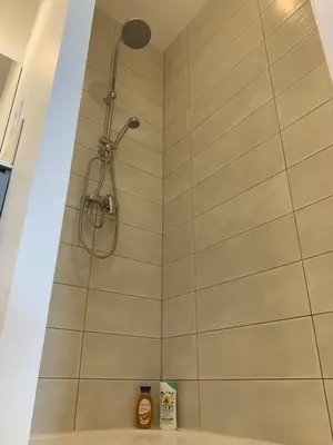 a shower with a shower head in a bathroom at Coup de cœur 4 étoiles en hyper centre, gare immédiate et canal du midi à 2 pas in Castelnaudary