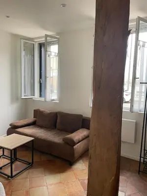 a living room with a couch and a table at Coup de cœur 4 étoiles en hyper centre, gare immédiate et canal du midi à 2 pas in Castelnaudary