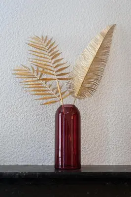 a red vase with a plant in it on a shelf at Maison La Majorelle - 90m2 - Garage et Terrasse in Pamiers