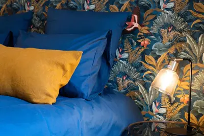 a bedroom with a blue bed with a yellow pillow at Maison La Majorelle - 90m2 - Garage et Terrasse in Pamiers