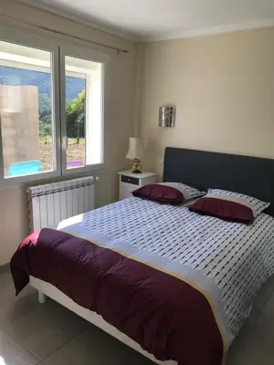 a bedroom with a large bed with a window at Els Pirineus in Molitg les Bains