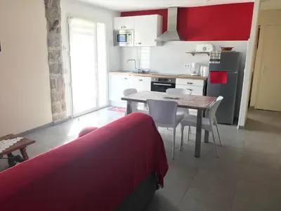 a kitchen with a table and chairs in a room at Els Pirineus in Molitg les Bains