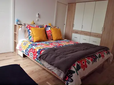 a bedroom with a bed with a colorful blanket at Gites de l'écluse 