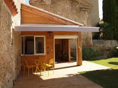 a patio with chairs and a building at Gites de l'écluse 