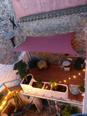 an overhead view of a patio with a purple umbrella at Maison Mômes in Bize-Minervois