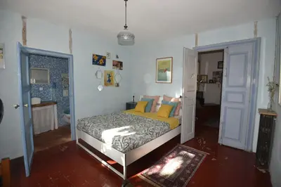 a bedroom with a bed in a room at Maison Mômes in Bize-Minervois