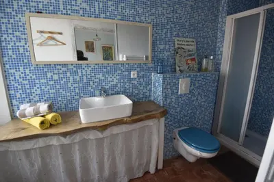 a bathroom with a sink and a toilet at Maison Mômes in Bize-Minervois