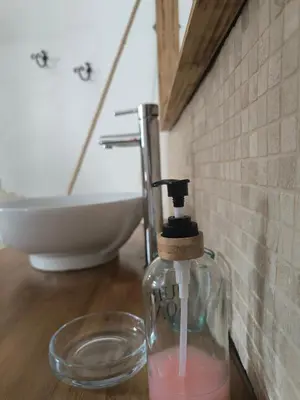 a white sink on a wooden counter in a bathroom at L’Antre d’Eux in Carcassonne