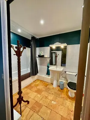 a bathroom with a toilet and a sink at Maison Saraphina in Cruzy