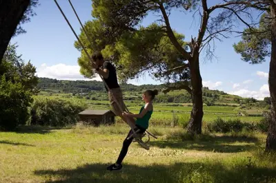 a man and a woman are playing in a field at Maison Saraphina in Cruzy