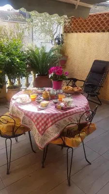 a table with food on it on a patio at Chambre d'hôtes chez Claude Bardou in Lacrouzette