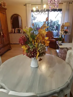 a vase of flowers sitting on top of a table at Chambre d'hôtes chez Claude Bardou in Lacrouzette