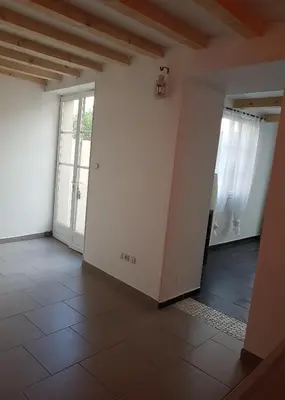 an empty room with white walls and a tile floor at Maison vue Cité 2 in Carcassonne