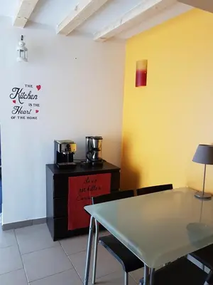 a dining room with a table and a coffee maker at Maison vue Cité 2 in Carcassonne