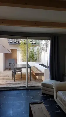 a living room with a view of a patio at Maison vue Cité 2 in Carcassonne