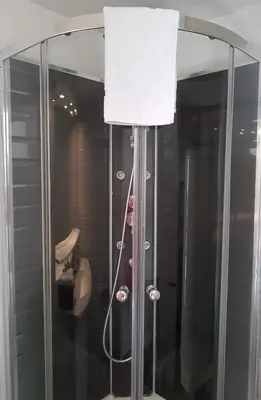 a shower with a white towel on top of it at Maison vue Cité 2 in Carcassonne