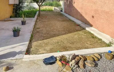 a garden with a pile of rocks next to a building at Cozy Home In Salles D'aude With Wifi in Salles-d'Aude