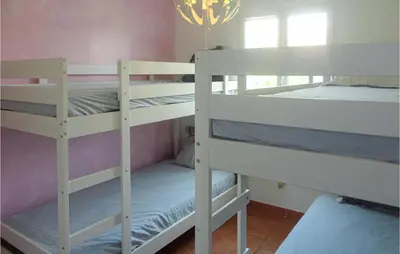 two white bunk beds in a room with a window at Cozy Home In Salles D'aude With Wifi in Salles-d'Aude