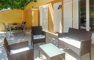 a patio with chairs and a table and a table and chairs at Cozy Home In Salles D'aude With Wifi in Salles-d'Aude