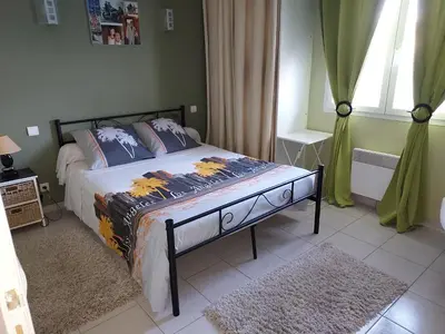 a bedroom with a bed and a window at Cher Micheée et Bernard in Camplong-dʼAude