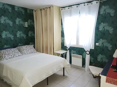 a bedroom with a bed and a window at Cher Micheée et Bernard in Camplong-dʼAude