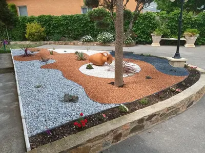 a garden with a statue of a bear in the middle at Cher Micheée et Bernard in Camplong-dʼAude