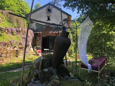 a house with a vase on top of a rock at Gîte Terra Bosca in Cambounès