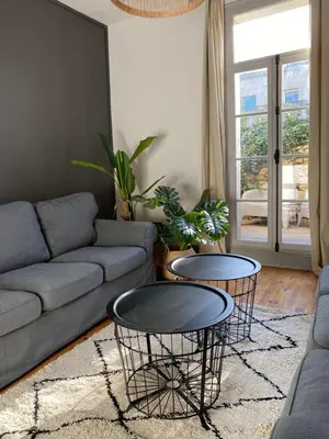 a living room with a couch and two tables at Maison rue Trivalle in Carcassonne