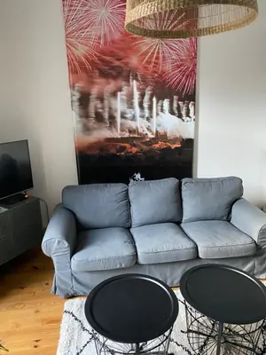 a living room with a couch and two tables at Maison rue Trivalle in Carcassonne