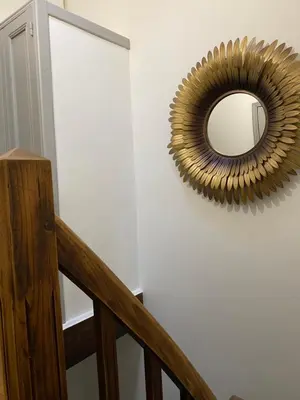 a mirror hanging on a wall next to a staircase at Maison rue Trivalle in Carcassonne