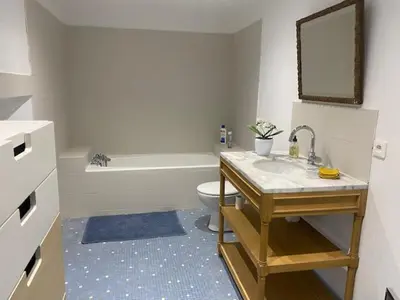 a bathroom with a sink and a toilet and a tub at Les Terrisses - Chambres d'hôtes avec piscine in Saint-Félix-Lauragais