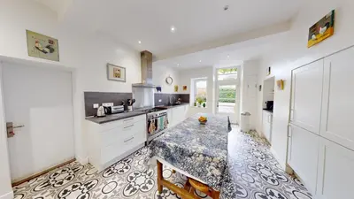 a kitchen with a table and a counter top at Les Terrisses - Chambres d'hôtes avec piscine in Saint-Félix-Lauragais