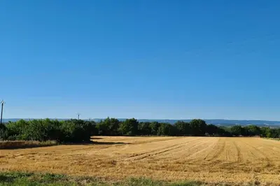 an empty field with a blue sky in the background at Diamond - Gîte dans vieux prieuré près de Carcassonne in Sainte-Eulalie