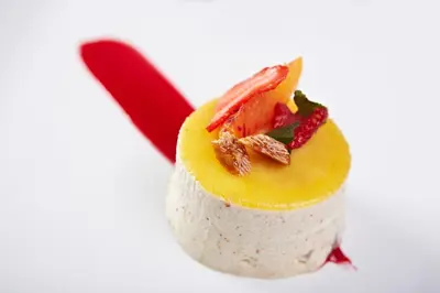 a dessert with fruit and nuts on top of it at Hôtel Mets et Plaisirs in Mazamet
