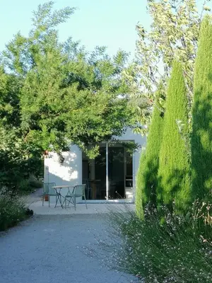 a house with a bench in front of it at Chambre d'hotes CHEVREFEUILLE in Molitg les Bains