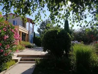 a house with a staircase leading to a garden at Chambre d'hotes CHEVREFEUILLE in Molitg les Bains